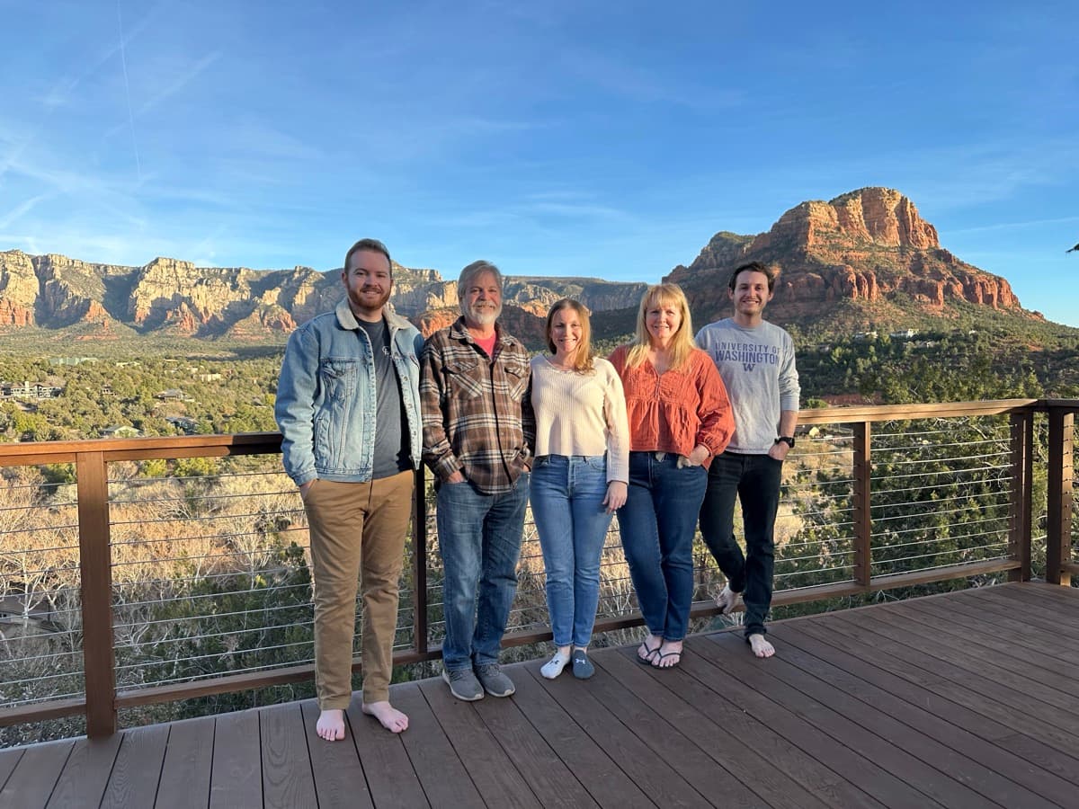 Collin, Dick, Shannon, Wendy and family on a deck in Sedona with red rocks behind